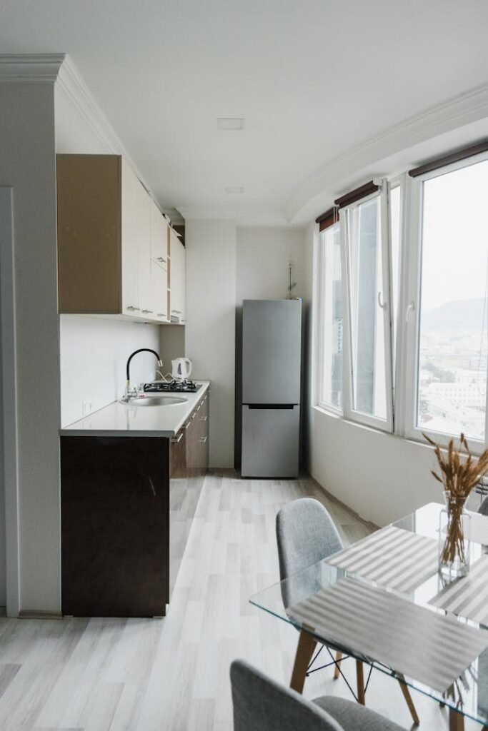 A Refrigerator in a Kitchen Near Glass Windows